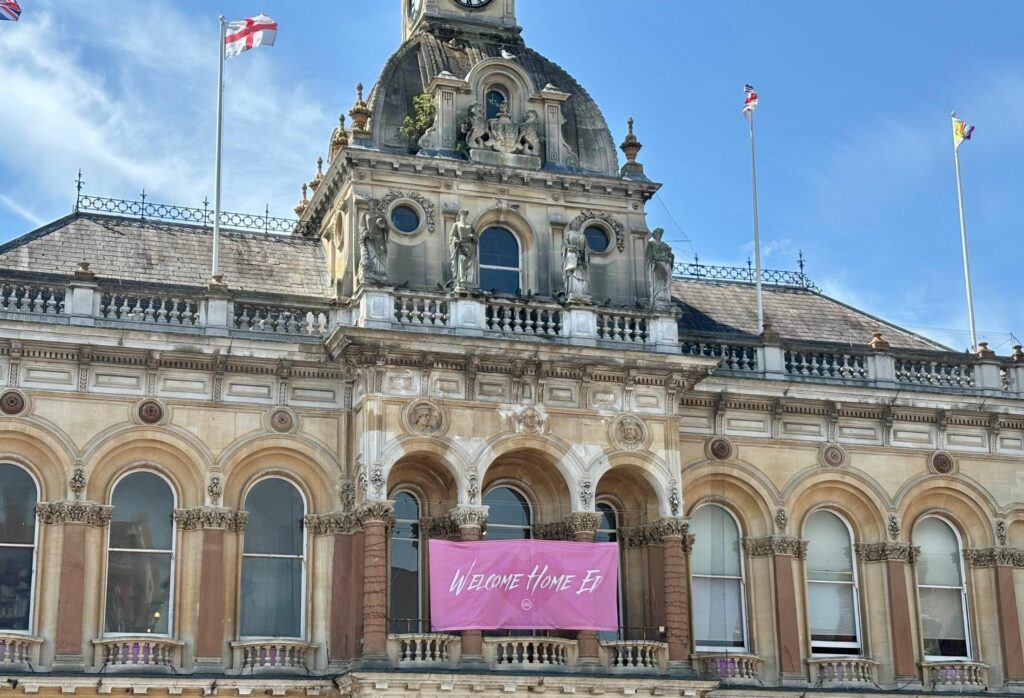 a photo of the cornhill ipswich displaying a welcome home ed banner